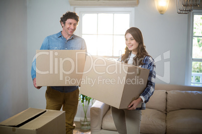 Couple holding cardboard boxes Couple holding cardboard boxes