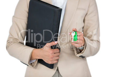 Businesswoman holding a file and key against white background