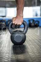 Cropped hand holding kettlebell