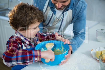 Father and son preparing cupcake