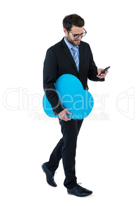 Businessman text messaging on mobile phone