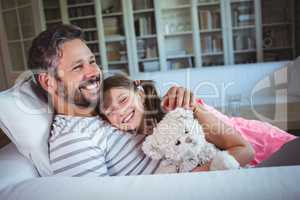 Father lying on sofa with daughter