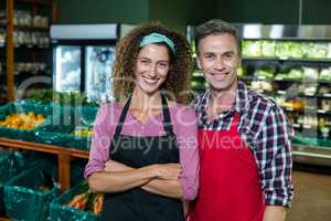 Smiling staffs standing together with arms crossed in organic section