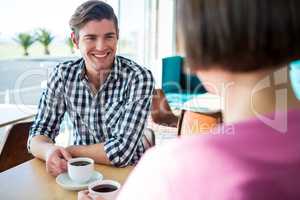 Man talking to a woman in coffee shop