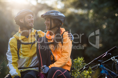 Biker couple sitting and interacting with each other