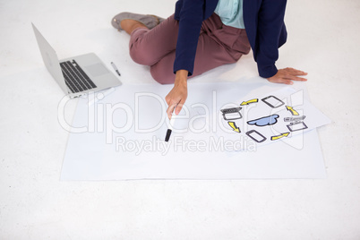 Businesswoman preparing a chart with icons