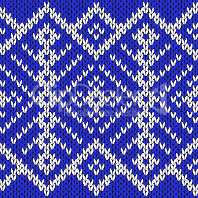 Knitting seamless ornate pattern in blue and white colors