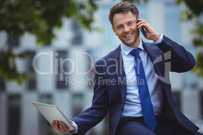 Handsome businessman talking on mobile phone