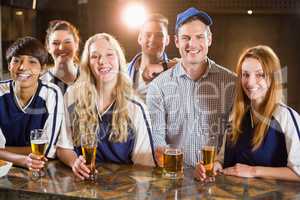 Group of friends having glass of beer in party