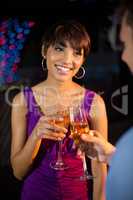 Couple toasting glass of champagne in bar