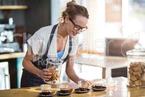 Waitress working at counter in cafÃ?Â©