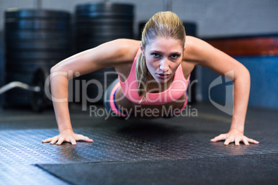 Determined woman doing push-ups