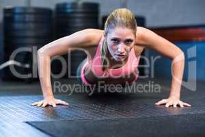 Determined woman doing push-ups