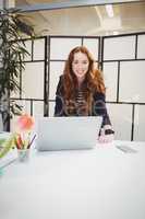 Portrait of confident businesswoman standing in meeting room at creative office