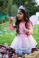 Girl blowing soap bubbles