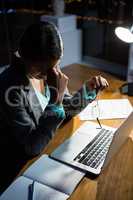 Stressed businesswoman sitting at her desk
