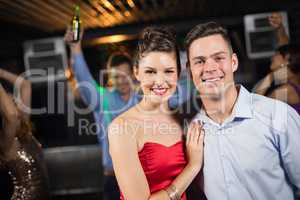 Cute couple standing together in bar