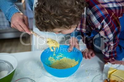 Father and son preparing cupcake