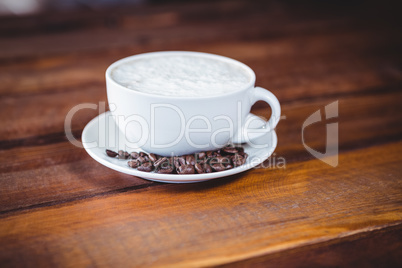 Coffee cup and beans on a table