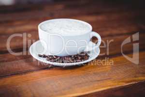 Coffee cup and beans on a table