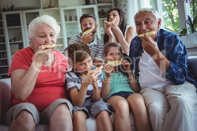 Multi-generation family having pizza together