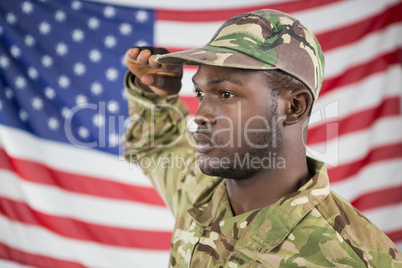 Soldier saluting against american flag