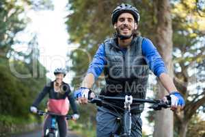 Biker couple cycling in countryside