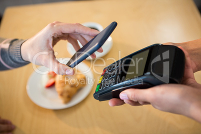 Woman making payment through smartphone