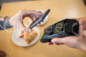 Woman making payment through smartphone