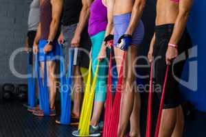 Athletes with resistance band in gym
