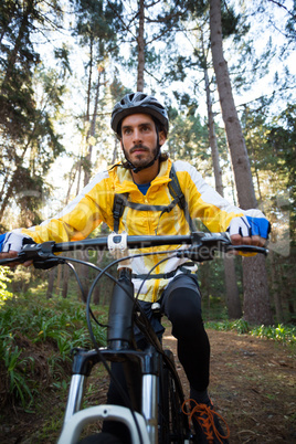 Male biker cycling in countryside