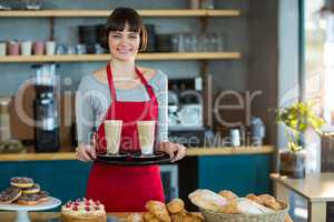 Portrait of waitress holding cup of cold coffee