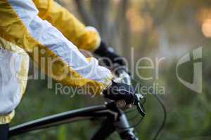 Mid-section of male biker with mountain bike