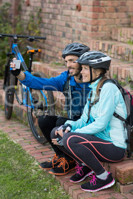 Biker couple taking selfie from mobile phone