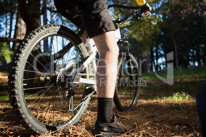 Low section of male mountain biker riding bicycle