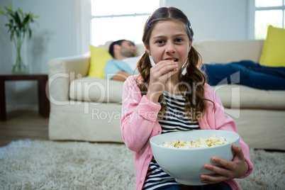 Girl eating popcorn in the living room