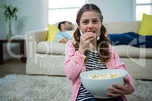 Girl eating popcorn in the living room