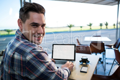 Man using his laptop in coffee shop