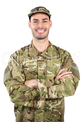 Portrait of smiling soldier standing with arms crossed