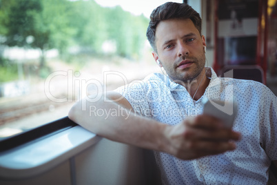 Handsome man listening music on mobile phone