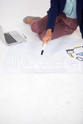 Businesswoman preparing a chart with icons
