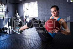 Young athlete holding exercise ball