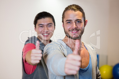 Happy men showing thumbs up