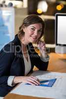 Businesswoman with blueprint in the office