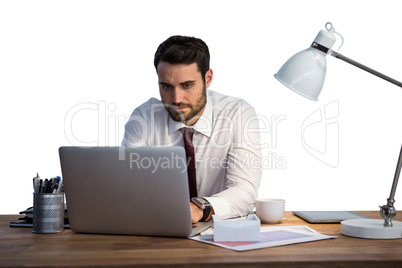 Businessman working on laptop in office