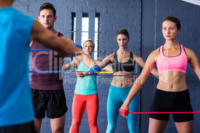 Athletes looking at trainer while exercising
