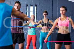 Athletes looking at trainer while exercising