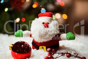 Santa claus and christmas ornaments on snow