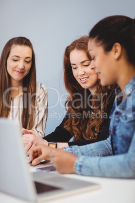 Businesswomen with laptop at desk Businesswomen with laptop at desk