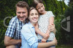 Portrait of happy family smiling in park